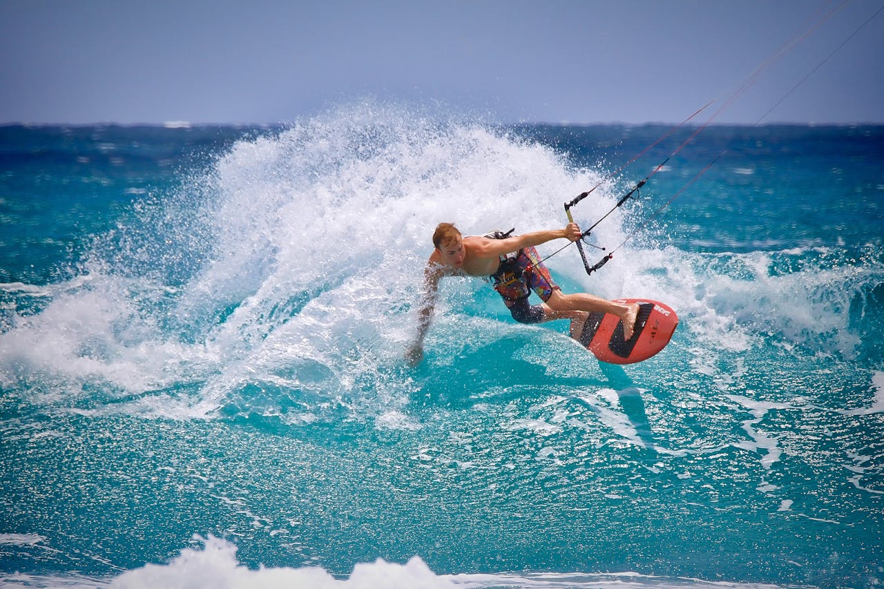 Services-02 Thrilling kitesurfing moment captured as a surfer rides the waves in vibrant ocean waters.